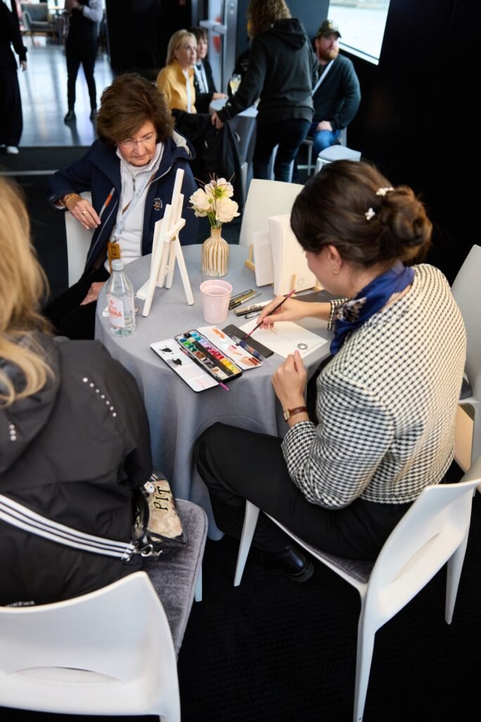 Live artist creating bespoke live portraits during a premium Seine cruise event in Paris.